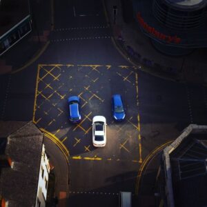 An aerial view of an intersection in Staffordshire, United Kingdom with cars and road markings.